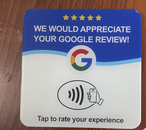 An NFC review card on a wooden counter.
